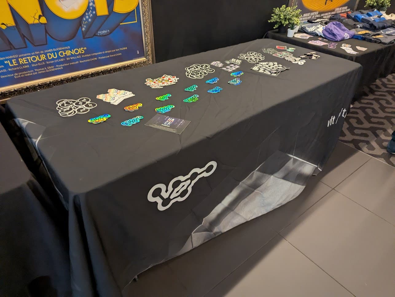 A table with many vlt branded stickers on it